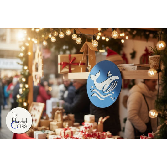 A vibrant and festive outdoor holiday market stall, decorated with string lights and Christmas greenery, with wrapped gifts and artisan goods on display, featuring a blue circular sign with a whale design.