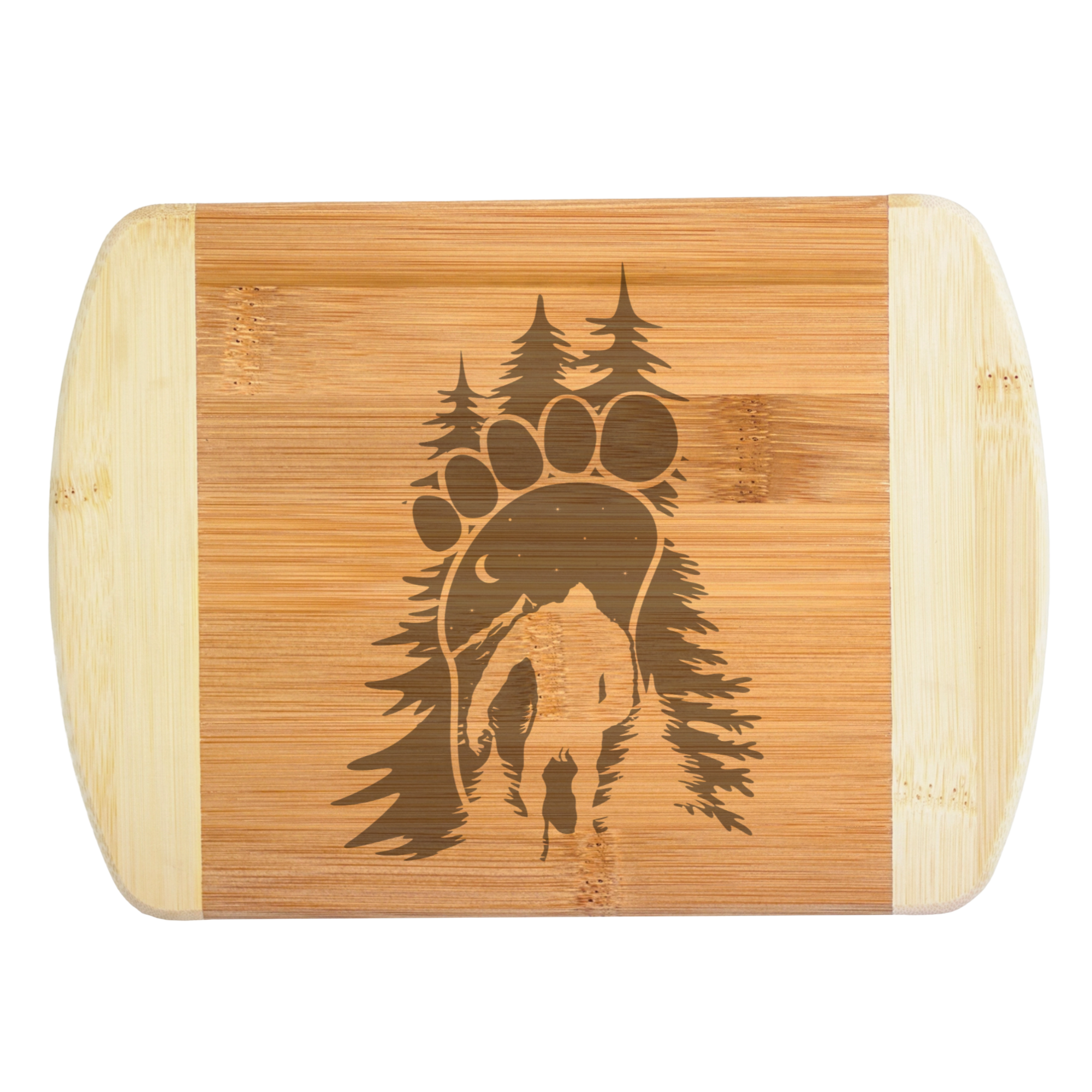 A premium engraved bamboo cutting board featuring an intricate illustration of a giant footprint framed by pine trees and filled with a crescent moon, starry night sky, mountains, and a walking Bigfoot silhouette, handcrafted by The Blended Oasis in Washington State.