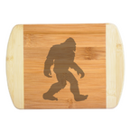 A premium engraved bamboo cutting board featuring the iconic classic silhouette illustration of a walking Bigfoot Sasquatch centered on the wood grain, handcrafted by The Blended Oasis in Washington State.