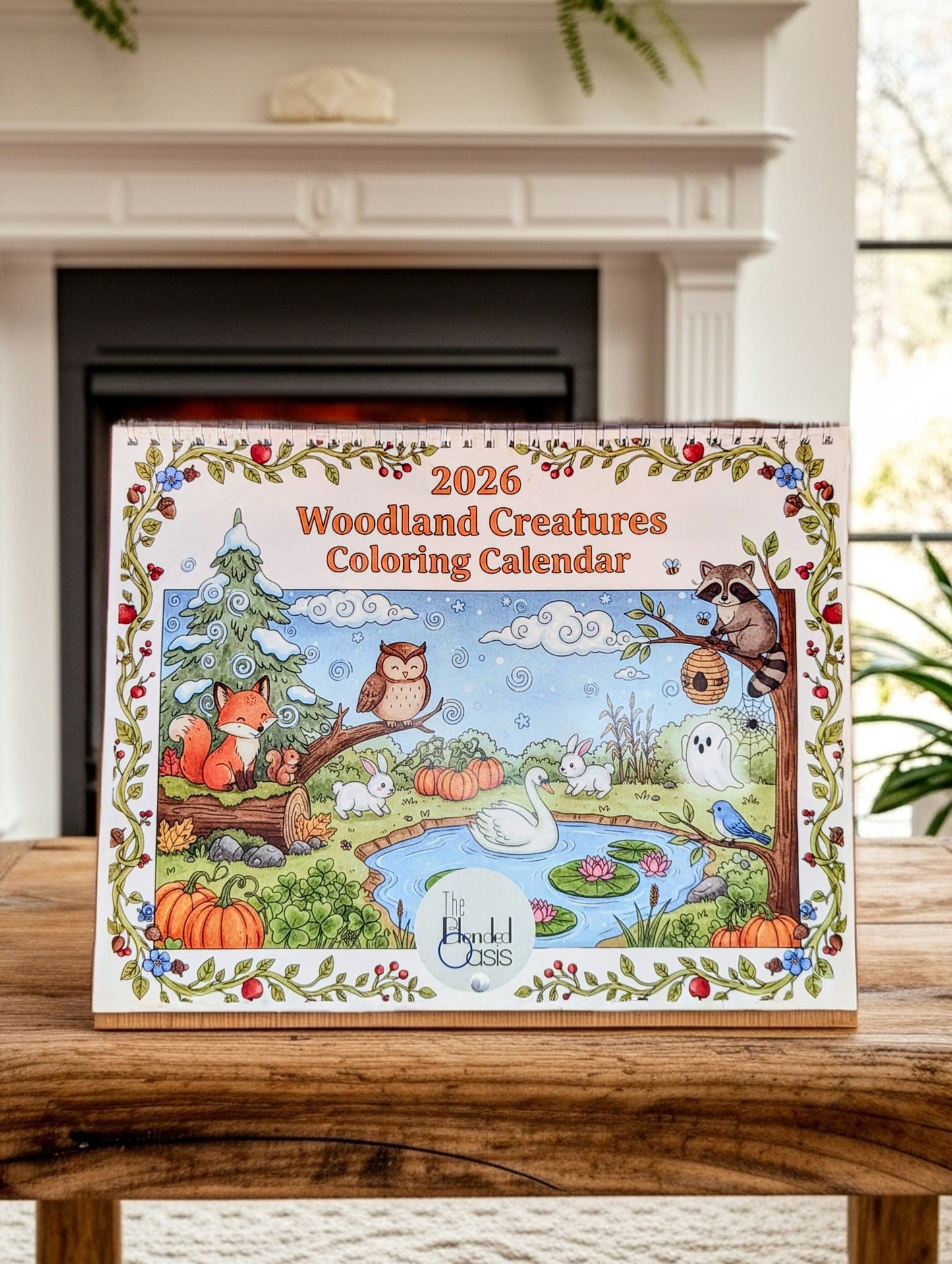 2026 Woodland Creatures Coloring Calendar on a wooden surface with a fireplace in the background