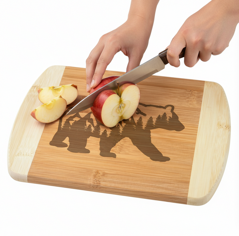 Person cutting apples on a wooden cutting board with bear design