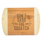 A premium engraved bamboo cutting board featuring a funny retro circular emblem layout that reads Don't Sass the Squatch, handcrafted by The Blended Oasis in Washington State