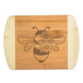A beautiful engraved bamboo cutting board showcasing a unique honeybee design with a delicate cluster of flowers on its wing, handcrafted by The Blended Oasis in Washington State.
