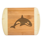 A premium engraved bamboo cutting board showcasing a clean, minimalist modern illustration of a breaching killer whale orca silhouette, handcrafted by The Blended Oasis in Washington State.