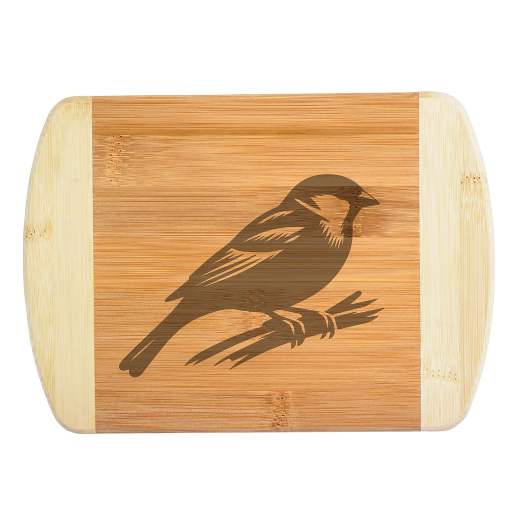 A premium engraved bamboo cutting board showcasing a classic wildlife illustration of a sparrow bird perched gracefully on a branch, handcrafted by The Blended Oasis in Washington State.