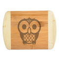 A premium engraved bamboo cutting board featuring a cute, whimsical modern illustration of a stylized owl with large round eyes, handcrafted by The Blended Oasis in Washington State.