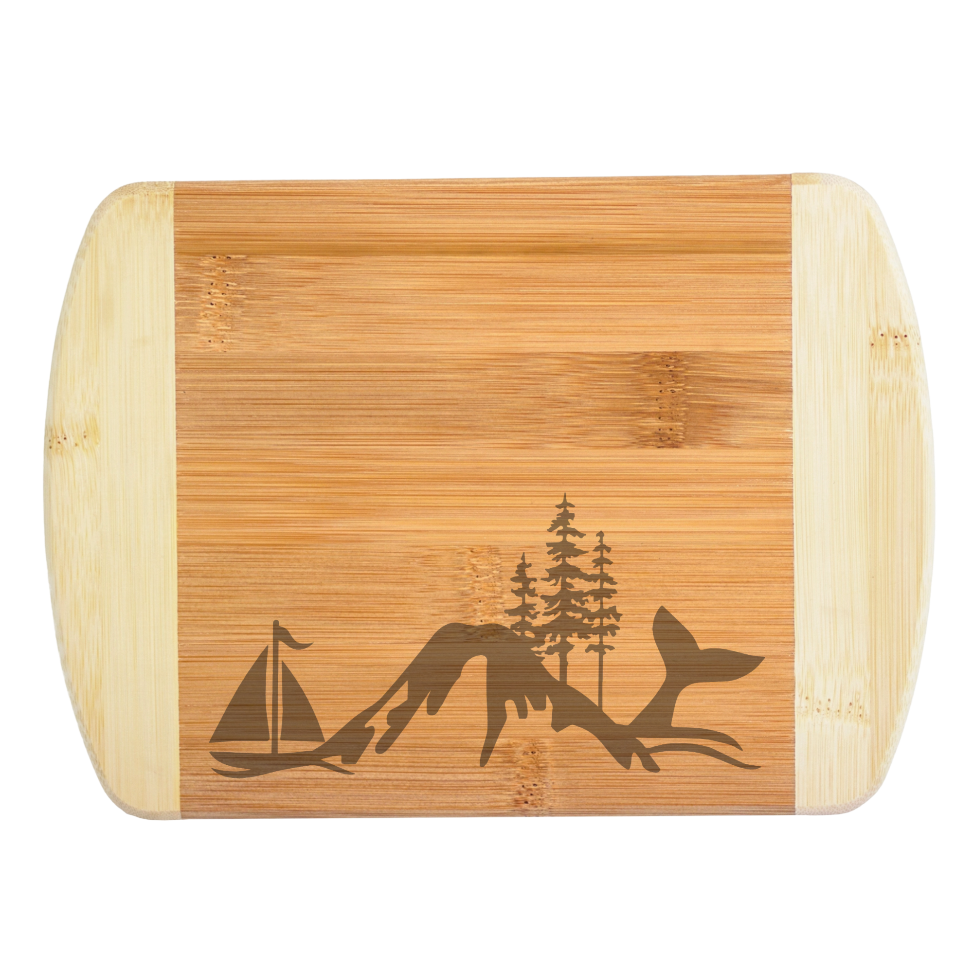 A premium engraved bamboo cutting board featuring a unique baseline illustration collage of a sailboat, mountain peak, evergreen pine trees, and a whale tail fluke, handcrafted by The Blended Oasis in Washington State.