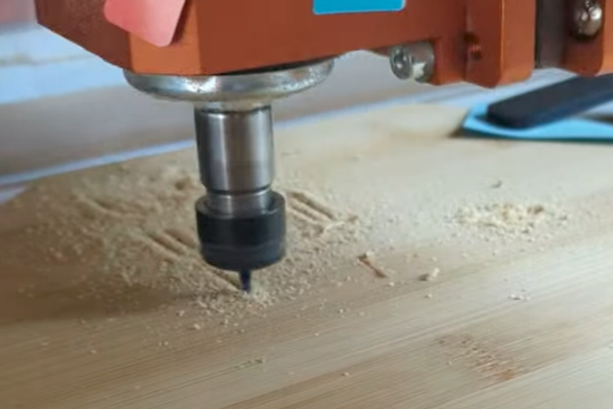 CNC machine in operation on a wooden surface