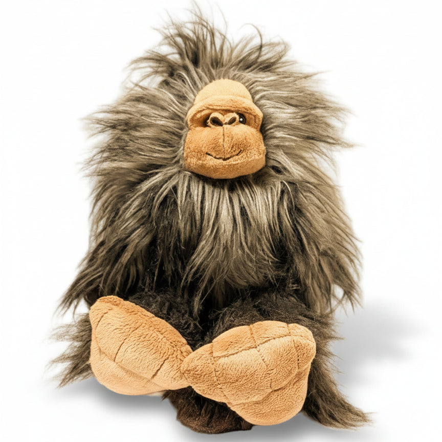 Plush toy resembling a creature with gray fur and brown face on a beige background