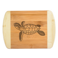 A premium engraved bamboo cutting board featuring a detailed modern illustration of a swimming sea turtle, styled beautifully on a warm kitchen counter next to fresh herbs, handcrafted by The Blended Oasis in Washington State.