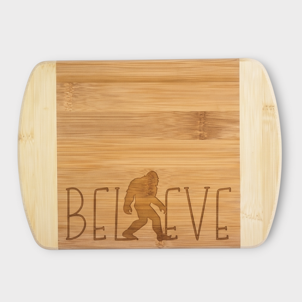 Believe Sasquatch Bamboo laser engraved board on light gray background.
