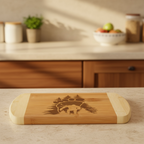 An artisanal charcuterie board from The Blended Oasis showcasing an engraved bigfoot sasquatch silhouette filled with a pine forest and a mountain landscape. The board rests on a light granite countertop with a soft kitchen background.
