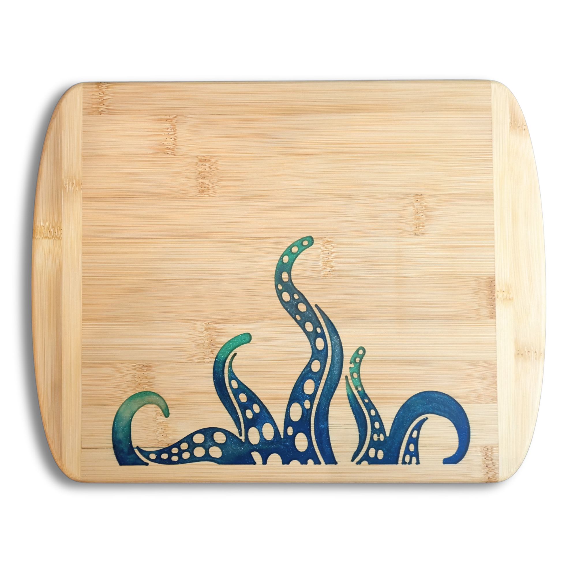 A top-down studio product photo by The Blended Oasis based in Suquamish, WA, showcasing a handcrafted bamboo cutting board. The lower edge features a deep ocean-blue and shimmering teal epoxy resin inlay of stylized kraken octopus tentacles. This PNW-inspired coastal decor piece is proudly handmade in Kitsap County near Poulsbo and the Puget Sound, serving art lovers across Washington, Oregon, and California. Set against a solid white background with a soft drop shadow.