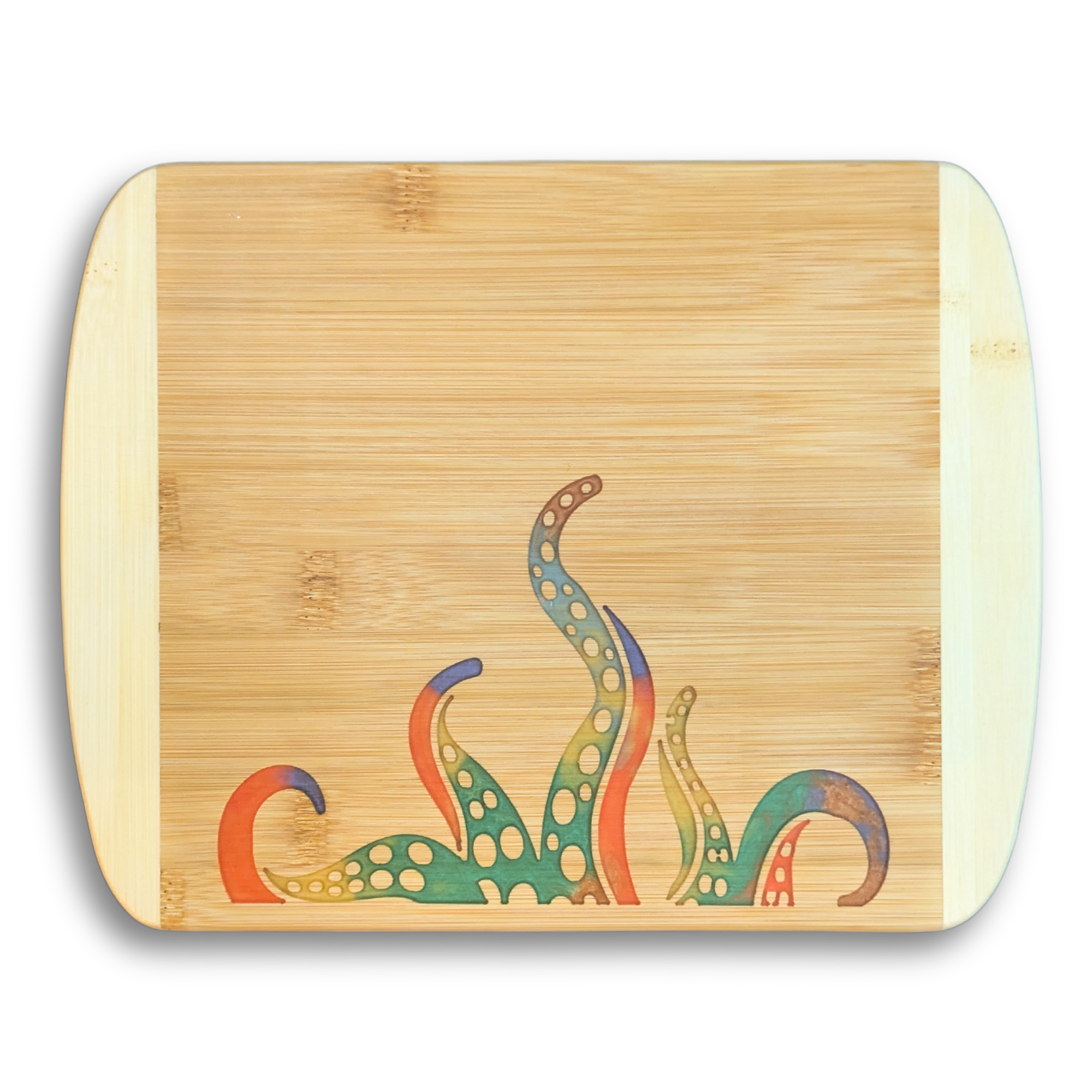 A top-down product photo by The Blended Oasis in Suquamish, WA, showing a handcrafted bamboo cutting board with rounded corners. The lower part of the board features a vibrant, colorful epoxy resin inlay depicting stylized kraken tentacles in shades of green, blue, purple, and orange. The upper right corner has a detailed laser etching that reads: 'Crafted in Kitsap, WA by The Blended Oasis. Marine Life Resin Collection'. Set against a plain white background with a soft drop shadow.