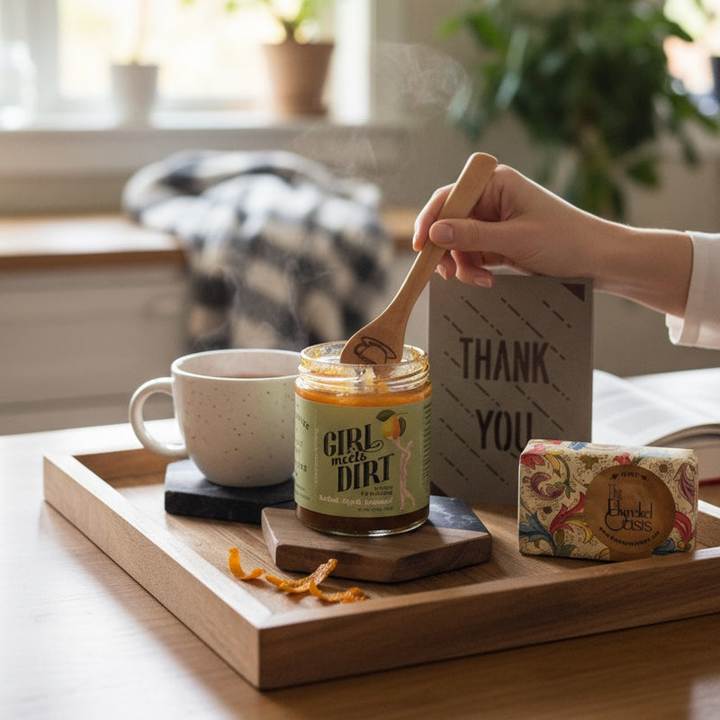 Person using a wooden spoon to scoop something from a jar labeled 'Girl Dirt' on a tray with a mug and other items.
