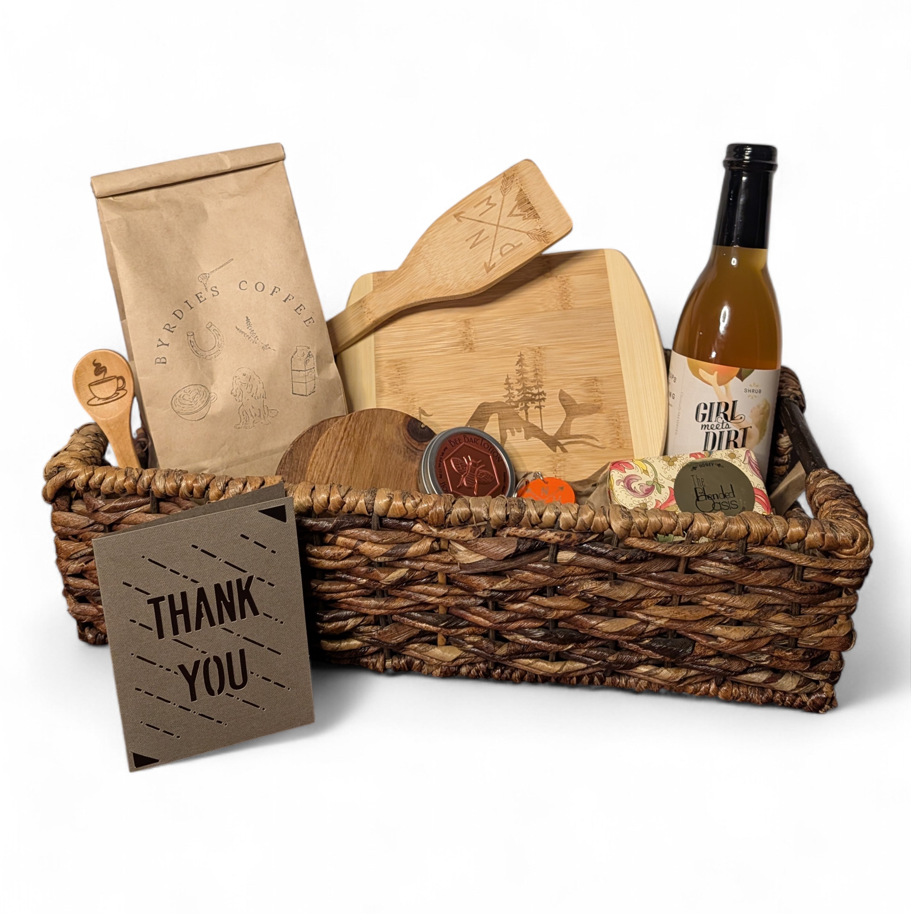 Gift basket with coffee, cheese board, and wine on a white background